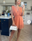 Sleeveless Mini Wrap Dress in coral color