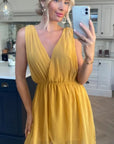 Sleeveless Mini Wrap Dress in mustard yellow color
