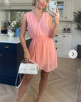 Sleeveless Mini Wrap Dress in peach pink color
