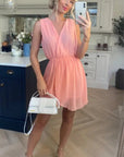 Sleeveless Mini Wrap Dress in peach pink color