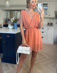 Sleeveless Mini Wrap Dress in coral color