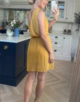 Sleeveless Mini Wrap Dress in mustard yellow color