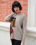 Un-finished tassel fringed knitted jumper